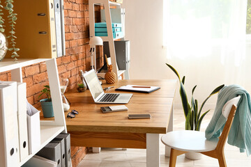 Interior of office with workplace and shelving units