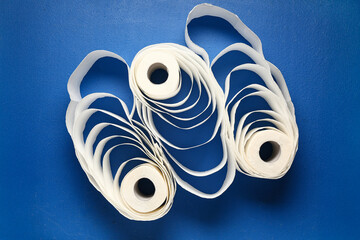 Rolls of toilet paper on blue background