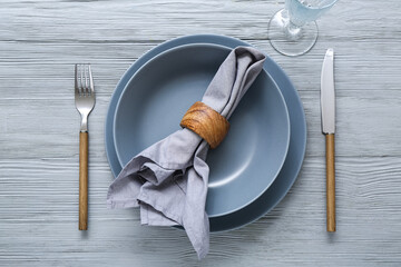 Stylish modern table setting on grey wooden background