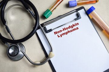 Concept of Non-Hodgkin Lymphoma write on paperwork isolated on Wooden Table. healthcare or Medical...