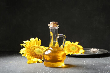 Decanter of sunflower oil on black background