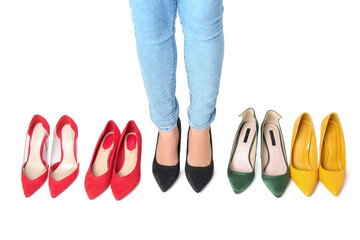 Woman with different shoes on white background