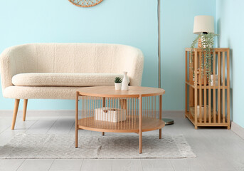Interior of living room with wooden coffee table and white sofa