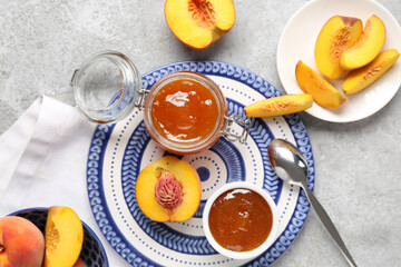 Composition with delicious peach jam and fresh fruits on grunge background