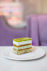 A piece of cake with mousse cream on a table in a pastry shop