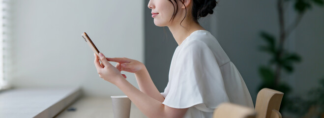 カフェでスマホを使う女性