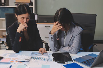 Asian women are stressed while working on laptop, Tired asian businesswoman with headache at...