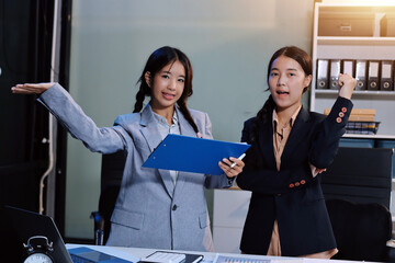  teamwork of tired young business with documents tax laptop computer in office. Sad, unhappy,...