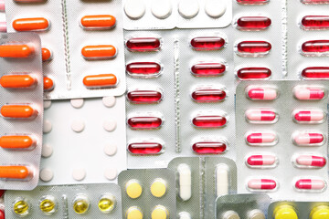 Blister packs with different pills as background