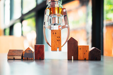 A robot lifting a house model, among others on a table, illustrates AI-powered real estate selection for optimized profit and minimized risk.