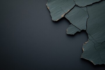 Dark textured surface with irregular shards showcasing unique ge