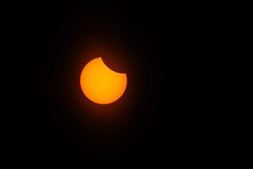 solar eclipse visible with light cloud cover