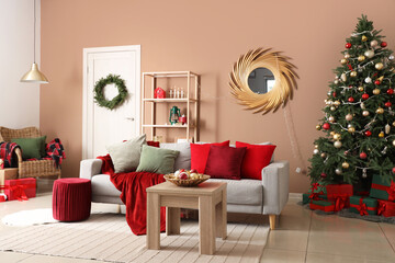 Interior of living room with sofa, table and Christmas tree