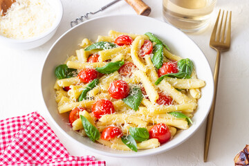 Pasta casarecce with tomatoes, basil and cheese. Italian cuisine. Vegetarian food.