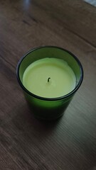 An aromatic candle placed on a wooden table