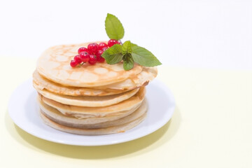 Red Currants and Fresh Mint with Pancakes on White Plate, Yellow and White Surface