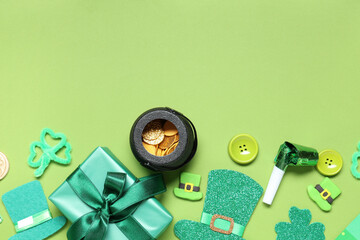 Gift box with pot of coins, party whistle and decor for St. Patrick's Day on green background