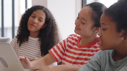 Smiling Three Diverse little girls learning together on a laptop in a classroom, showing joy, Multiethnic children with E-learning and online classroom in a relaxed educational.	 - Powered by Adobe