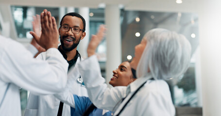 High five, doctor and group in hospital, success and happy for achievement, healthcare and wellness. Accomplishment, medical professional and people with smile in clinic, support and gesture for win