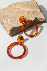 Beautiful earrings with rock on light background