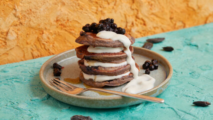 Mini pancake stack with blueberries and white cream topping