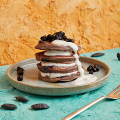 Mini pancake stack with blueberries and white cream topping