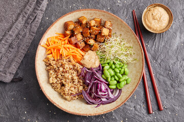 Quinoa edamame tofu bowl with red cabbage and carrots