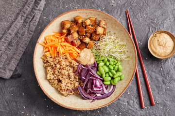Quinoa edamame tofu bowl with red cabbage and carrots