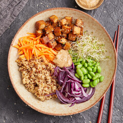 Quinoa edamame tofu bowl with red cabbage and carrots