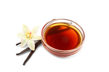 Bowl of vanilla extract, sticks and flower on white background
