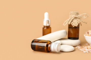 Beautiful composition of bottles with natural cosmetics on brown background