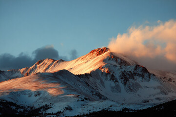 breathtaking sunrise illuminating majestic mountains of colorado with clear sky and soft clouds