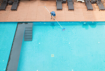 Pool maintenance with scoop net to capturing the leaves on the surface of pool.