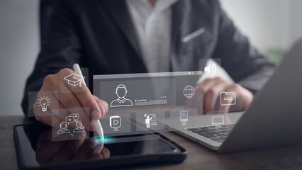 Businessman using laptop for e-learning, education, learning and online training with webinars and...