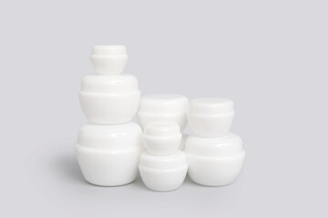 Composition with jars of cosmetic products on grey background