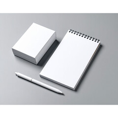  White Stylus and Notepad with Packaging on Grey Desk