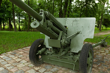 Military green cannon on the fort. Artillery weapon from the Second World War