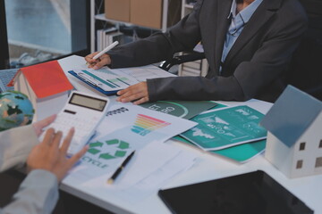 Asian woman lead young group of multiethnic businesspeople in team meeting, using laptop computer for ESG topic presentation on monitor. Sustainable business practice, people work at home concept