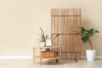 Beautiful interior of room with coffee table, houseplant and folding screen