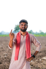 Young Indian farmer showing finger after voting
