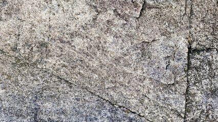 Close-up of a natural mountain rock surface featuring rough and organic textures. Ideal for use in backgrounds, design elements.