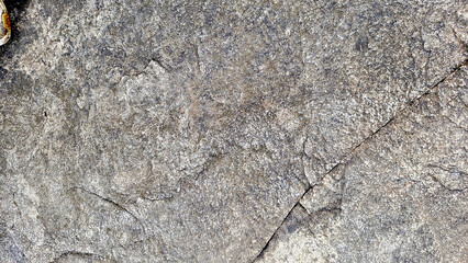 Close-up of a natural mountain rock surface featuring rough and organic textures. Ideal for use in backgrounds, design elements.