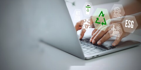 A business person using laptop with esg concept on visual screen.