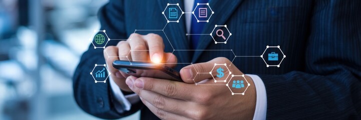 Businessman using a smartphone with digital interface overlays.