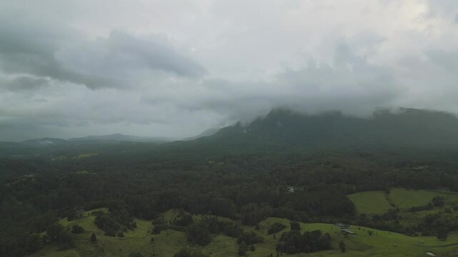 Dark and gloomy low clouds over mountains and pastures