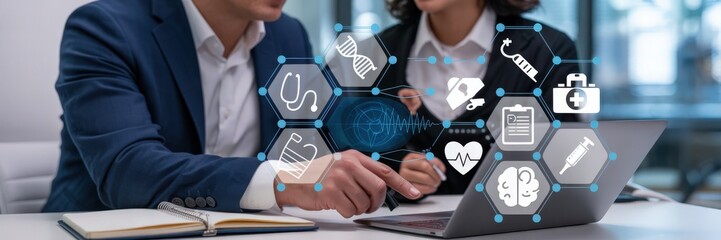 Two people collaborating on a digital healthcare interface.