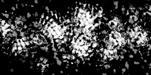 Obraz premium White snowflakes on a black background surface. Macro nature pattern backdrop. Snow overlay background isolated on black. Winter concept. scratches and cracks which can be used as a background.