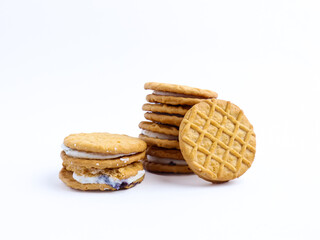 Stack of sandwich cookies with cream and blueberry filling on a white background