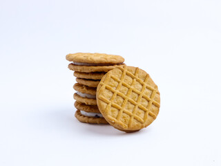 Stack of sandwich cookies with cream and blueberry filling on a white background