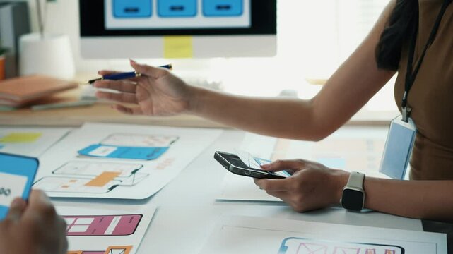 Female UXUI professional designing mobile app interface, sketching on paper and smartphone, strategizing user centered digital solution for innovative application development